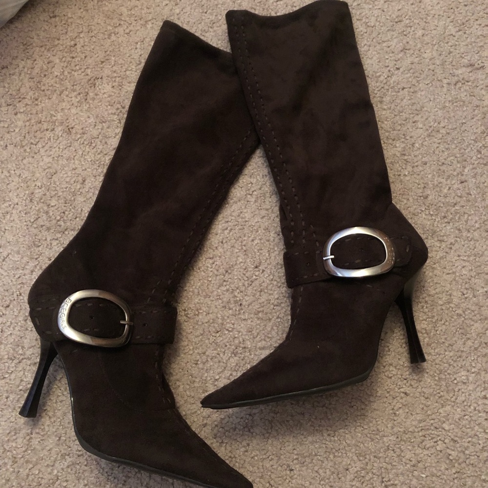 Dark brown pointed toe high heel boots.